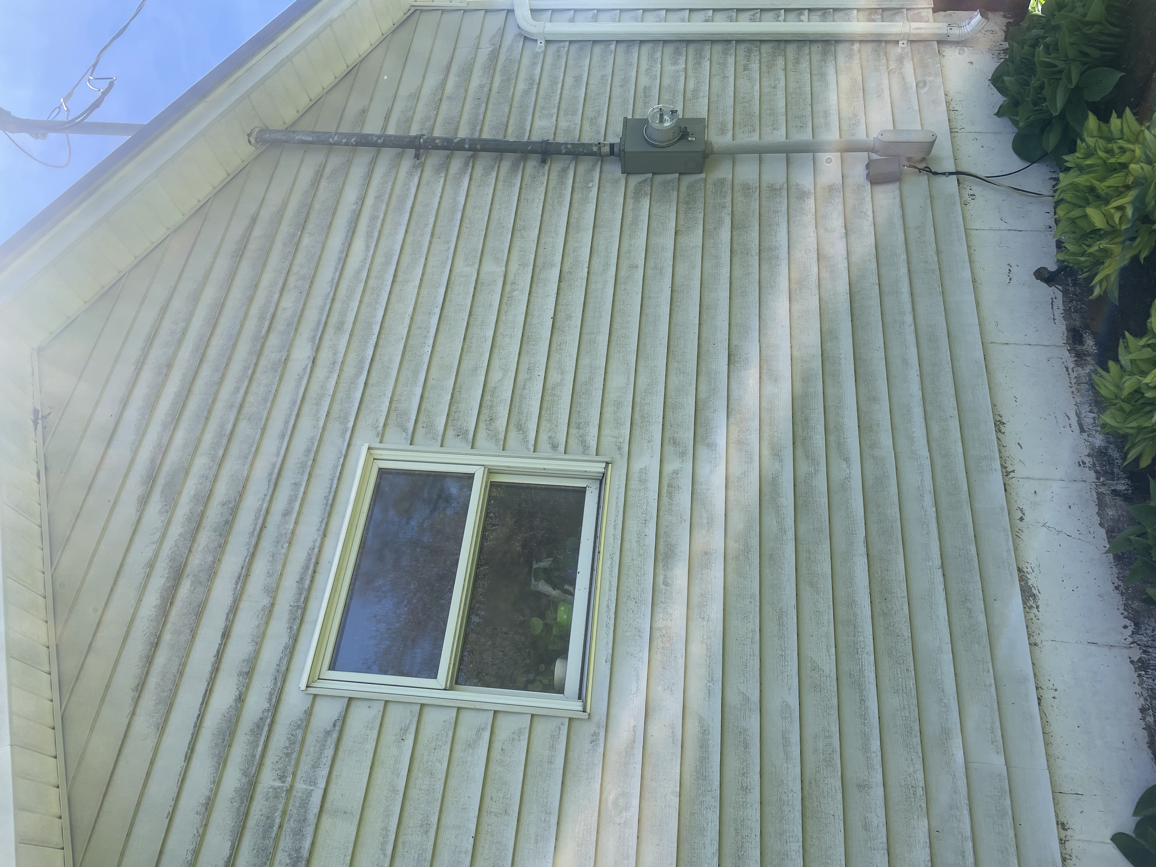 Stained siding before washing